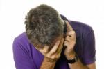 5288741-man-in-purple-shirt-receiving-bad-news-on-phone.jpg