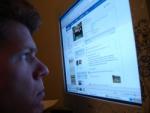 Guy staring at Facebook