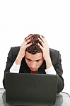Young_caucasian_worried_businessman_with_a_laptop.jpg