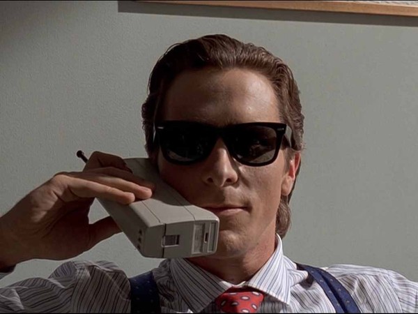 Patrick Bateman looking badass talking on a giant 80s cell phone