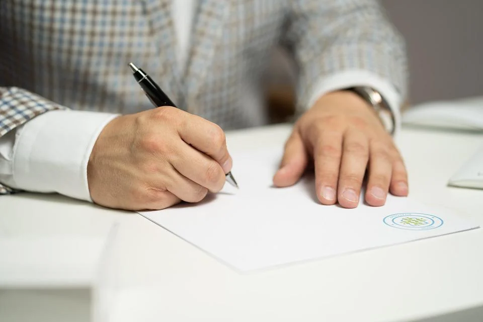 A person signing a paper